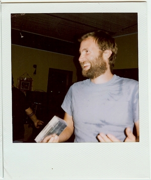 Paul Baribeau smiling in a Polaroid photo