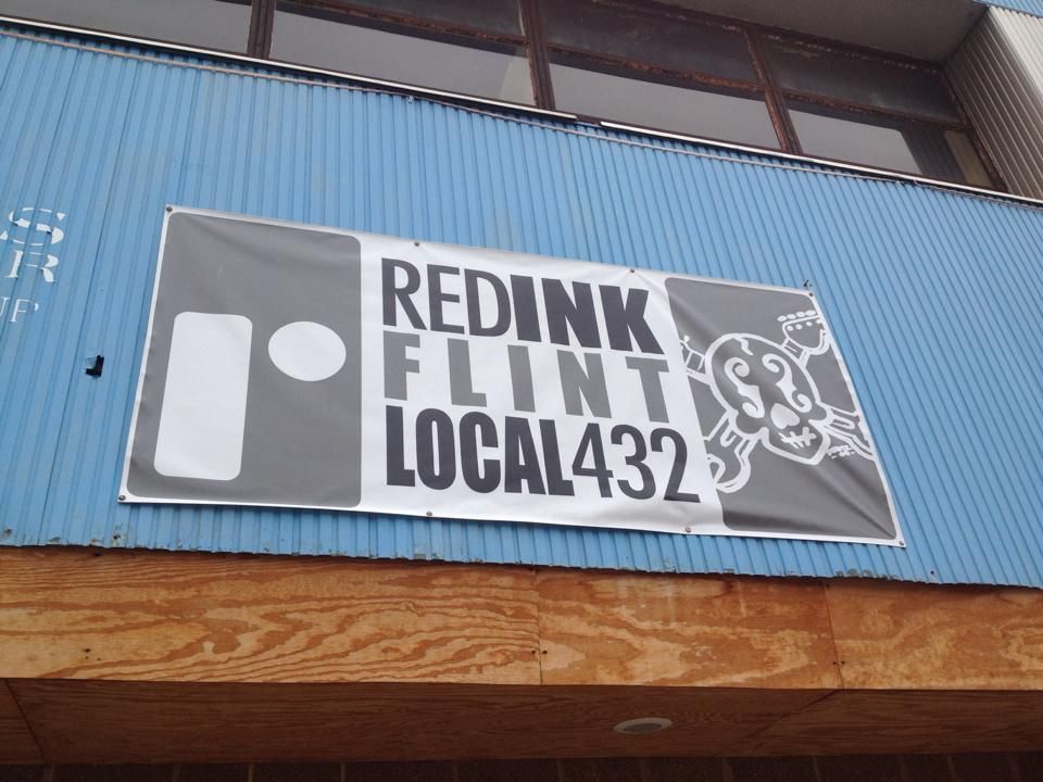 Banner on the side of a building reads REDINK Flint Local 432