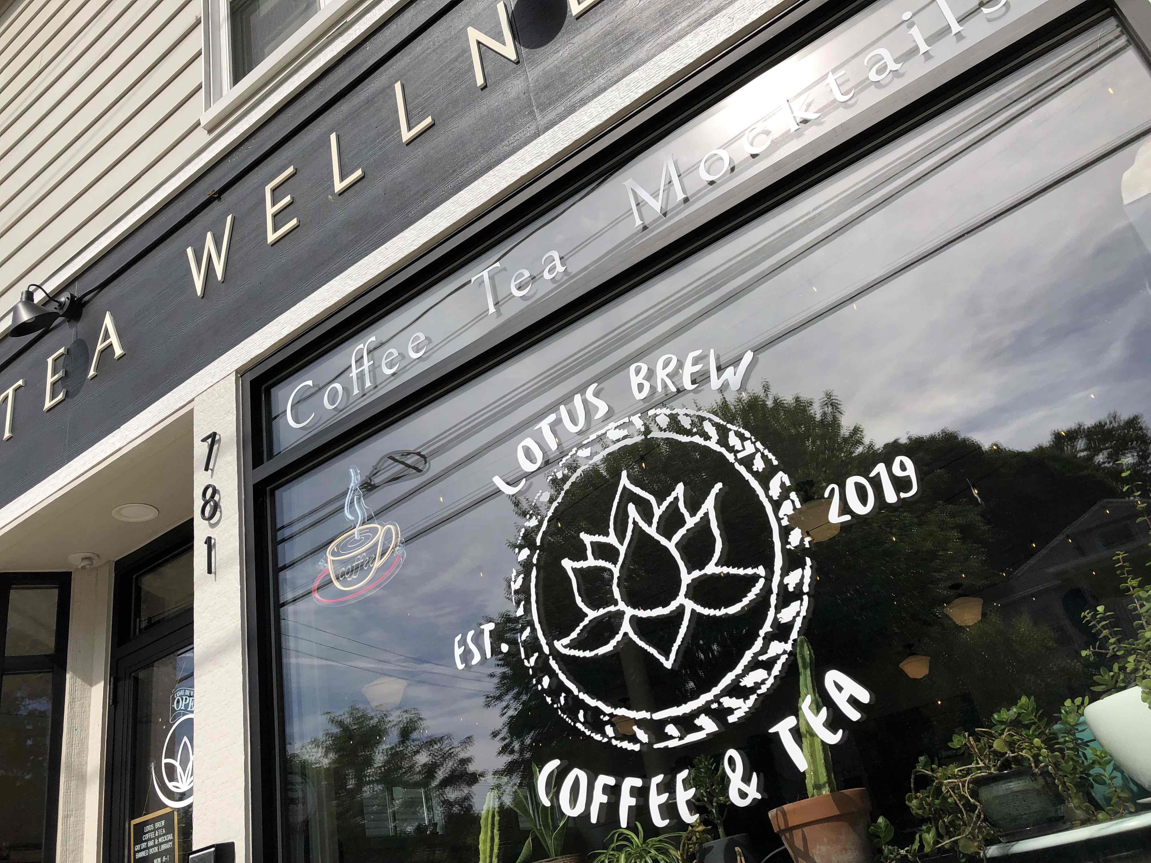 Lotus Brew Coffee & Tea Est. 2019 storefront with logo signage on the glass