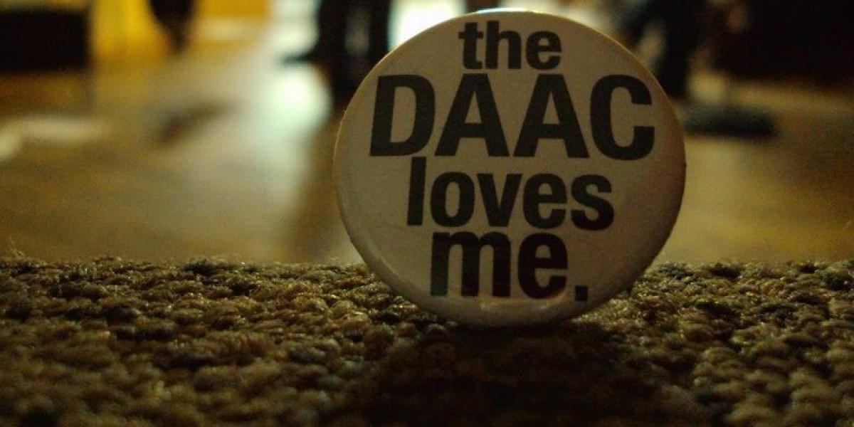 Close up photo of a button with the text The DAAC Loves Me