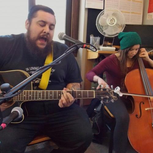 Guitarist and cellist performing live in studio