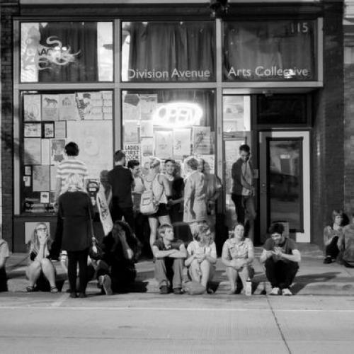 Crowd gathers on the curb outside 115 Division Avenue